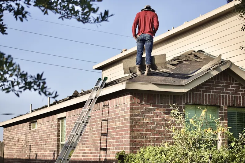 Professional roofer working on a residential roof in Oak Meadow